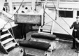 Injured soldier being winched on board hospital ship PLASSY in a makeshift stretcher