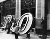New neon sign being installed at P&O's West End office at 14-16 Cockspur Street, May 1956